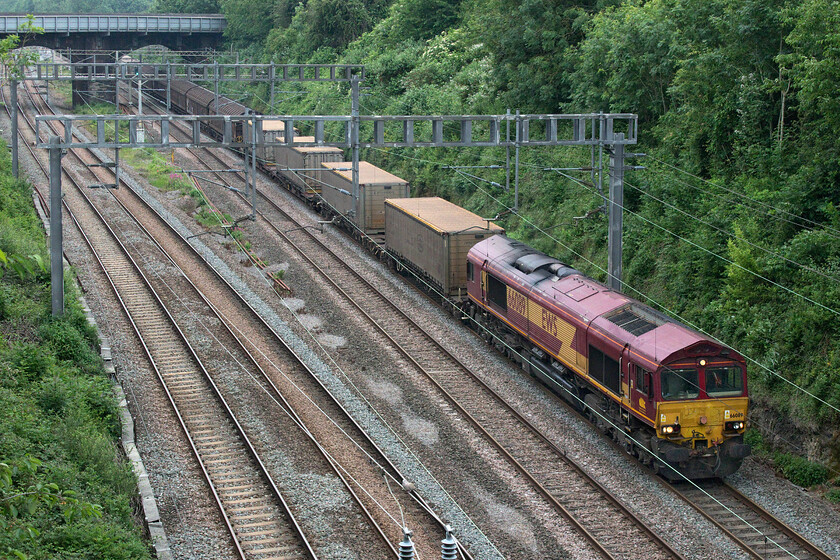 66089, 09.36 Dollands Moor-DIRFT (6C24, 19E), Hyde Road bridge 
 Having never actually photographed 66089 working a train (only having one photograph of it in Wembley Yard) I capture it twice in two days! Yesterday I saw it at Victoria bridge, see..... https://www.ontheupfast.com/p/21936chg/30015949282/x66089-11-38-wembley-dirft-6m45-victoria and today it is on the same train but with different timings and operating number. 66089 leads the 09.36 Dollands Moor to DIRFT (Daventry) bottled water train through Roade taken from the village's Hyde Road bridge running as 6C24. It is interesting today as it's on the down fast line thus taking the Weedon route to Rugby where the locomotive will run round to make the short journey to DIRFT entering from the north. This is one of the Class 66s still running in their original EWS 'Three Beasts' livery. 
 Keywords: 66089 09.36 Dollands Moor-DIRFT 6C24 Hyde Road bridge EWS