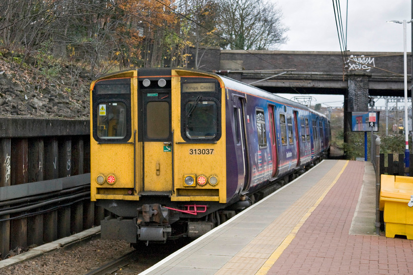 313057 & 313059, 08.26 London King's Cross-Stevenage (2F12), Alexandra Palace station 
 313057 leaves Alexandra Palace at the rear of the 08.26 King's Cross to Stevenage with 313059 out of sight on the front. I had just alighted from this train making the short trip from Hornesy. 
 Keywords: 313057 313059 08.26 London King's Cross-Stevenage 2F12 Alexandra Palace station Great Northern