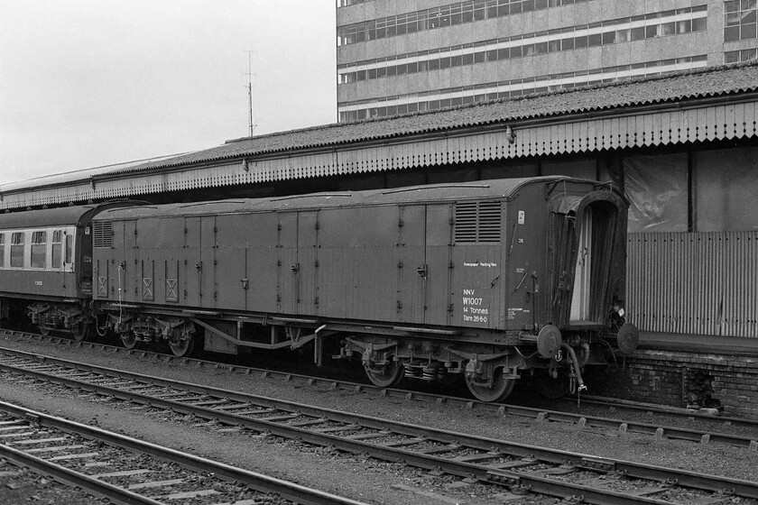 W1007, Gloucester station 
 Taken from my train as it waits to leave Gloucester station a former GWR Siphon 'G' ventilated milk van (NMV) is seen on the adjacent platform. W1007 dates from 1955 and was Swindon built being converted for newspaper use with fluorescent lighting installed becoming an NNV. This particular example was to survive a further three years in service being condemned in 1984. 
 Keywords: W1007 Gloucester station GWR Siphon G was a Ventilated Milk Van NMV