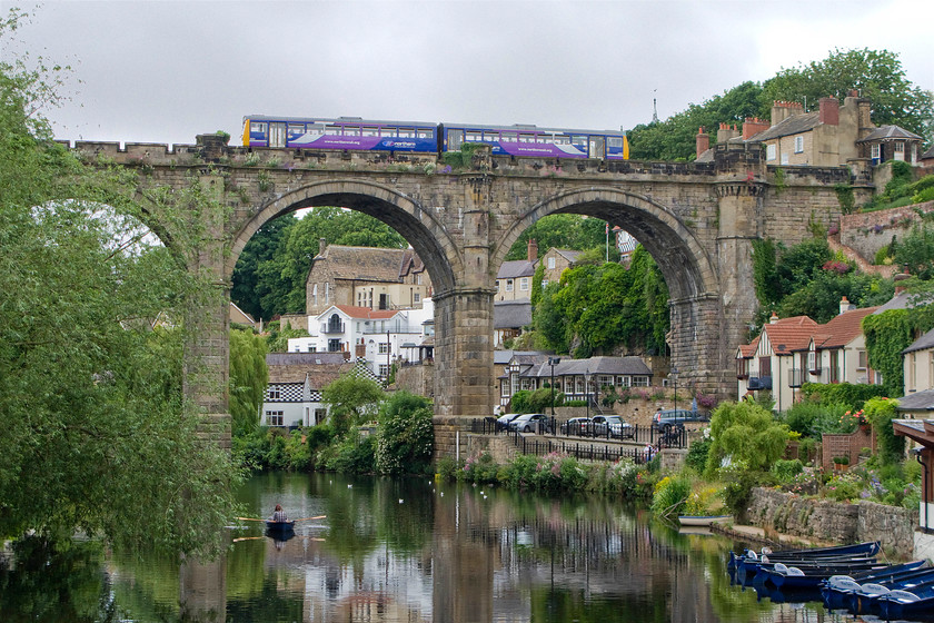 Class 14X, NT 13.11 York-Leeds (2C33), Knaresborough viaduct 
 The town of Knaresborough is situated just east of Harrogate and is a charming town that is popular with tourists. Looking at this view down by the River Nidd it is easy to understand why it is so popular. Indeed, on the strength of our fleeting visit to collect a car, my boss then spent a long weekend here with his wife a few weeks after this picture was taken. With the glorious viaduct in full view, a Pacer leaves the station, located out of sight to the right, with the 13.11 York to Leeds service. Notice the smashing signal box joined to the end of the terraced houses in the top right of the image, an alternative view can be seen at..... https://www.ontheupfast.com/v/photos/21936chg/28195221804/x170472-11-11-york-leeds-2c33-11l 
 Keywords: Pacer 13.11 York-Leeds 2C33 Knaresborough viaduct Northern Rail