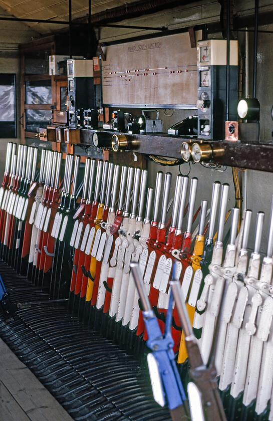 Interior, March South Junction signal box 
 Graham and I were invited into March South Junction signal box by the signalman on duty on this balmy Sunday afternoon. The LNER box that was opened in 1927 with a fifty-one lever frame that looks as though it is largely intact as seen in this photograph. In the best traditions of mechanical signalling, the handles of the levers and the brass-work of the indicators are kept spotless and polished within an inch of their lives! The box is still in use today at the time of writing in 2023 with no planned date for its closure as yet but, good luck with an invite inside! 
 Keywords: Interior, March South Junction signal box.jpg