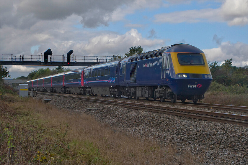 43196, GW 07.41 Penzance-London Paddington (1A16), South Marston foot crossing SU193869 
 With the sun having just popped behind a cloud the 07.41 Penzance to Paddington HST service passes South Marston near Swindon with power car 43196 leading. This service is one of a number of West of England trains that take the Bristol route rather than via the more normal Berks. and Hants. line. In this view looking westwards, there is absolutely no evidence of the forthcoming electrification that is now hopelessly behind schedule however, there was a closure notice attached to the style of the foot crossing where I was standing. 
 Keywords: 43196 07.41 Penzance-London Paddington 1A16 South Marston foot crossing SU193869 First Great Western HST