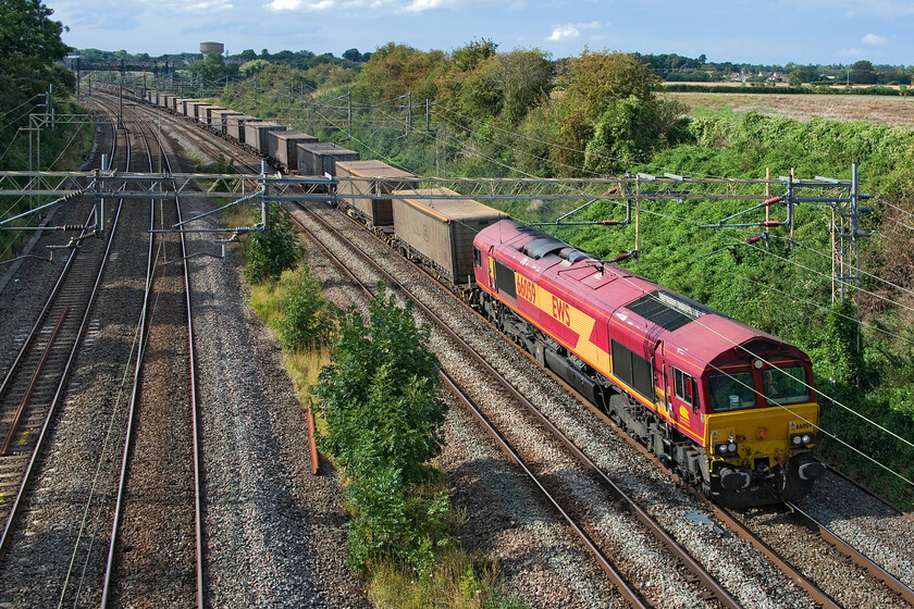 66059, 11.15 Ditton Foundry-Dollands Moor (6O26), Victoria bridge 
 Still resplendent in its full EWS livery complete with full branding despite the company ceasing to be since November 2007 66059 heads south past Victoria bridge leading the 6O26 Ditton Foundry to Dollands Moor service. When DB Cargo UK bought out EWS in 2007 they announced that there would be no rebranding however, by 2009 this policy had changed and revealed 59209 in their new DB Schenker livery at York's National Railway Museum in the January of that year. They did not seem in a rush to work their way through the many locomotives on their books with another minor rebranding having taken place since from DB Schenker to DB Cargo in the meantime! 
 Keywords: 66059, 11.15 Ditton Foundry-Dollands Moor 6O26 Victoria bridge EWS