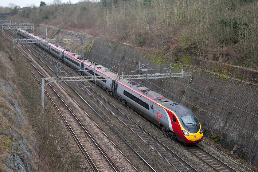 390047, VT 11.43 London Euston-Glasgow Central (9S65), Roade Cutting 
 This 11.43 Euston to Glasgow Central train will arrive at its destination early on Christmas Eve evening. It is being worked by 390047, one of the original nine-car formations and is seen passing northwards through Roade Cutting. 
 Keywords: 390047 11.43 London Euston-Glasgow Central 9S65 Roade Cutting