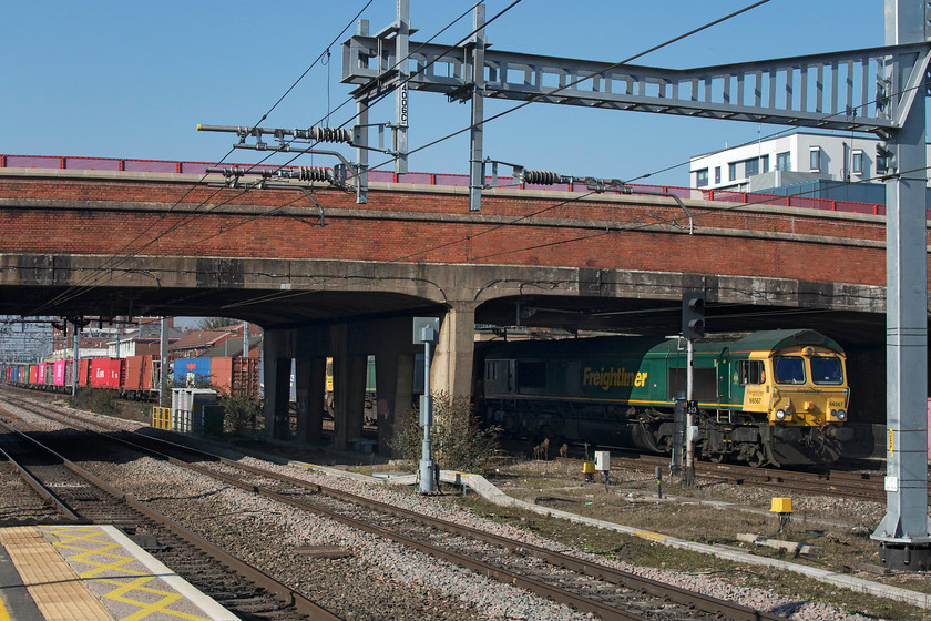 66567 & 66519, 09.25 Southampton-Garston FLT (4M28), Slough station 
 This picture perfectly illustrates the problems created by the installation of the electrification paraphernalia when trying to take photographs. 66567 is seen emerging from under Slough's William Street bridge but, unfortunately, 66519, that is tucked in behind, is out of view. The 66s are leading the 09.25 Southampton to Garston FLT 4M98 Freightliner. This working is often double-headed and is one that I have photographed on the WCML near to my home at Roade. 
 Keywords: 66567 66519 09.25 Southampton-Garston FLT 4M28 Slough station