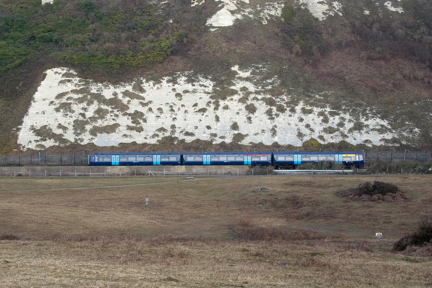 375304, SE 08.05 Ramsgate-London Charing Cross (2W26, RT), Samphire Hoe Country Park TR286388 
 A broadside picture of 375304 passing under the famous white cliffs working the 08.05 Ramsgate to Charing Cross. Thirty years ago, I would have been standing in the sea to take this image as all the land in the foreground is formed from chalk spoil removed during the digging of the channel tunnel. The new land is now the Samphire Hoe country park that is owned by Eurotunnel who also have a presence on the site at the eastern end where the ventilation plant for the tunnel is housed in some large and heavily secured buildings. 
 Keywords: 375304 08.05 Ramsgate-London Charing Cross 2W26 Samphire Hoe Country Park TR286388