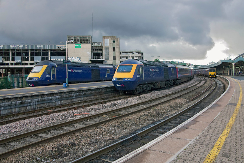 43196, GW 15.00 Bristol TM-London-Paddington (1A22), 43029, GW 12.57 London-Paddington-Bristol Parkway (Severn Tunnel Diversion) (1C15) & 150122, GW 12.41 Worcester Foregate Street-Weymouth (Cancelled from Yeovil Pen Mill (2O90), Bristol TM station 
 Under dramatic skies at Bristol Temple Meads three First Great Western trains are pictured. To the left, 43196 will soon leave with the 15.00 to London Paddington. Next to it, 43029 is preparing to leave to make the short journey to Bristol Parkway as the 12.57 from Paddington. This train was routed via Bath and terminated at Parkway due to engineering works on the Badminton route and the closure of the Severn Tunnel. Finally, to the right, 150122 is waiting to leave forming the 12.41 Worcester Foregate Street to Weymouth that was, unfortunately, terminated at Yeovil Pen Mill. This scene is dominated by the hulk of the former Royal Mail sorting office. The remains of this building have dominated and blighted Temple Meads (and this part of Bristol for that matter) for many years since its closure with various plans for its redevelopment never coming to anything. 
 Keywords: 43196 15.00 Bristol TM-London-Paddington 1A22 43029 12.57 London-Paddington-Bristol Parkway Severn Tunnel Diversion 1C15 150122 12.41 Worcester Foregate Street-Weymouth 2O90 Bristol TM