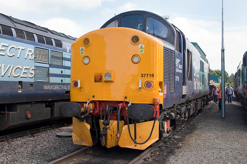 37716, on-display, DRS Gresty Bridge 
 37716 is on-display at Crewe Gresty Bridge's open day and looks as though it's hi-viz front end has had a coat of fresh yellow paint. 37716 took this number from 37094 early on in 1985. It is amazing that after being service for over fifty years now that it is still going strong undertaking front-line duties. 
 Keywords: 37716 DRS Gresty Bridge