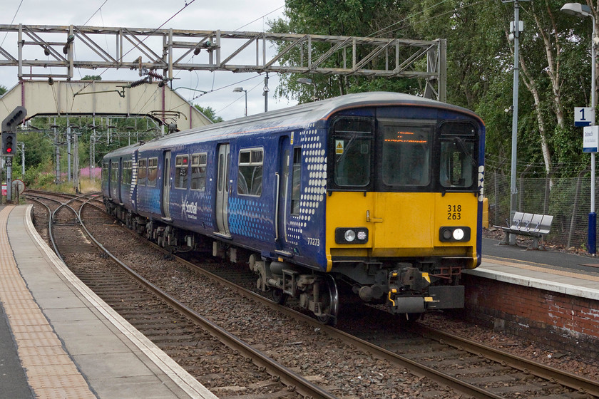 318263, SR 14.07 Balloch-Airdrie (2E60), Dalreoch station 
 318263 comes off Dalreoch Junction and into the station of the same name. It's forming the 14.07 from Balloch to Airdrie 2E60 working. 
 Keywords: 318263 2E60 Dalreoch station