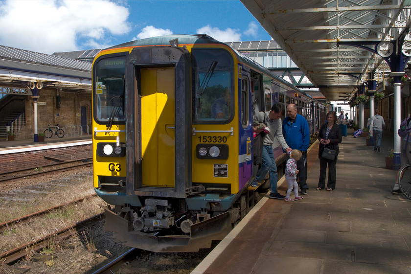 153330, NT 12.08 Carlisle-Barrow-in-Furness (2C48), Workington station 
 A busy scene at Workington station where I have just alighted from 153330. I travelled on the Northern Trains service from Carlisle as the 12.08 to Barrow-in-Furness. Workington station is large but is somewhat of a shadow of its former self with the platforms having been truncated and many lines, as seen here, now either removed or out of use. Mr. Cameron will have to work hard in places such as Workington if his Northern Powerhouse has any legs! 
 Keywords: 153330 12.08 Carlisle-Barrow-in-Furness 2C48 Workington station Northern Trains