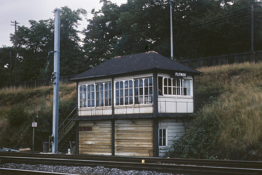 Flitwick signal box (Midland, date not known) 
 In the dying evening light, Flitwick signal box is seen located just to the north of the station, adjacent to the up slow line. Another Midland box of a later design and one that I do not have a date of construction for. Note the electrification mast that has been installed as part of the wiring of the southern MML as far as Bedford, a scheme that was completed in 1983. 
 Keywords: Flitwick signal box