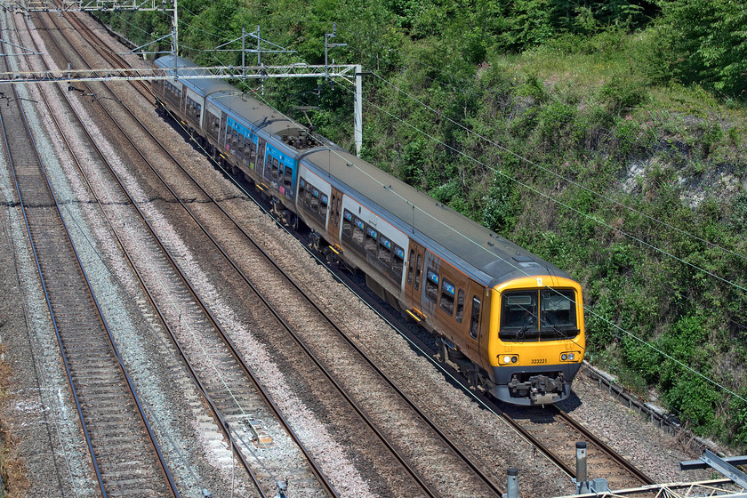 323221, 10.49 Soho LMD-Wolverton centre sidings (5Z23, 1E), Hyde Road bridge 
 A little off its usual tracks West Midlands Railway's 323221 passes through Roade cutting as the 10.49 Soho depot to Wolverton. There has been a regular procession of these fairly elderly units in and out of the Knorr-Bremse owned and operated works as they are in receipt of upgrading and improvements. 
 Keywords: 323221 10.49 Soho LMD-Wolverton centre sidings 5Z23 Hyde Road bridge London West Midlands Railway WMR