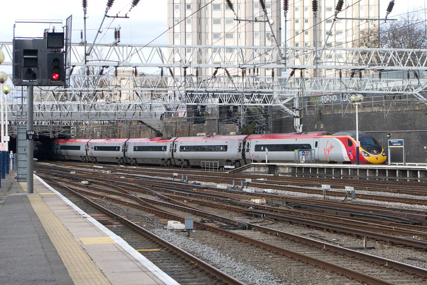 390103, VT 13.17 London Euston-Manchester Piccadilly (1H11), London Euston station 
 Virgin's 390103 'Virgin Hero' leaves Euston with the 1H11 13.17 to Manchester Piccadilly. Notice that it's carrying the Royal British Legion World War I commemorative branding and poppies. 
 Keywords: 390102 13.17 London Euston-Manchester Piccadilly 1H11 London Euston station