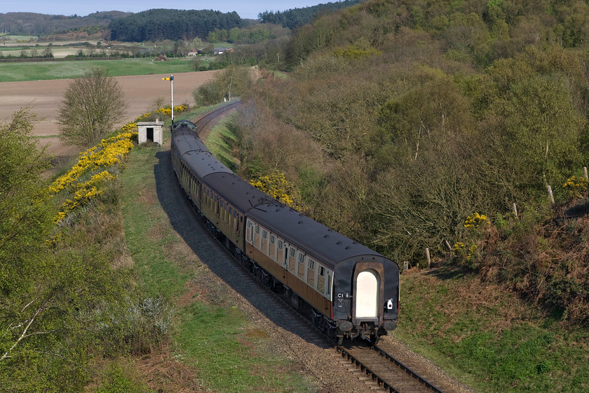 8572, 16.30 Holt-Sheringham, Kelling bank 
 Former LNER B12 8572 gingerly descends Kelling bank leading the 16.30 Holt to Sheringham, the final North Norfolk Railway service of the day. It is about to pass Weybourne's distant signal and it may be stopping at Kelling halt that is just around the curve in the tress subject to any passenger wanting to alight. Steam services will only stop on return workings such as this with them not able to do so coming in the other direction climbing the bank. 
 Keywords: 8572 16.30 Holt-Sheringham Kelling bank Poppy Line NNR North Norfolk Railway LNER B12 4-6-0