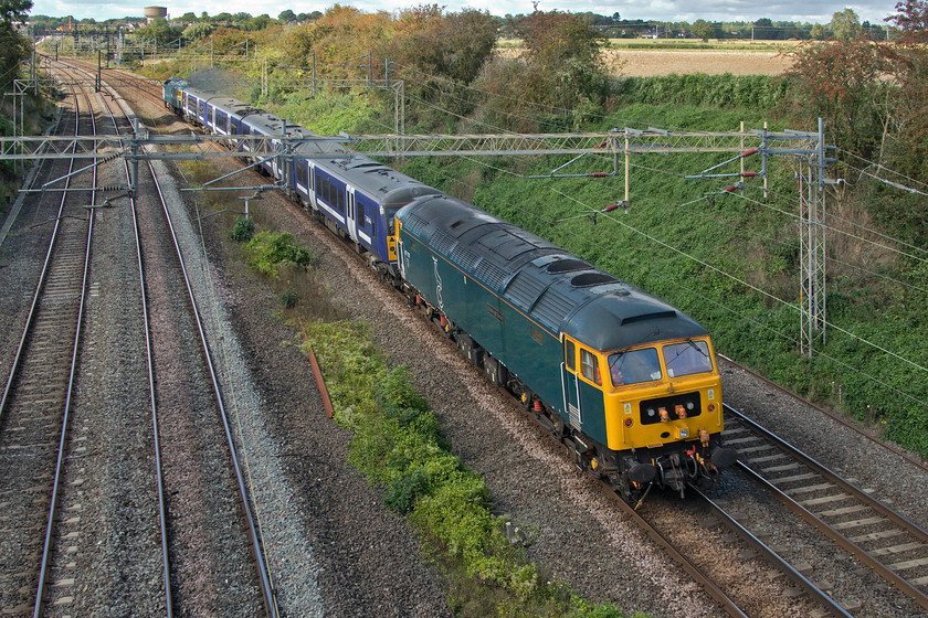 47727, 360120 & 47749, 11.21 Ilford EMUD-Northampton EMD (5Q60, 1E), Victoria bridge 
 Notice that the front of the train in the distance is in full sun and the rear in the foreground is in the shade - such is the nature of railway photography! 47749 'Edinburgh Castle/Caisteal Shun Eideann' is seen dead in tow attached to the rear of 360120 passing Victoria bridge between Roade and Ashton. 47727 'City of Truro' is towing the train that will soon arrive at its destination and deposit the Class 360 for modification work at Siemens' Kingsheath depot to enable 110mph operation. 
 Keywords: 47727 360120 47749, 11.21 Ilford EMUD-Northampton EMD 5Q60 Victoria bridge City of Truro Edinburgh Castle Caisteal Shun Eideann