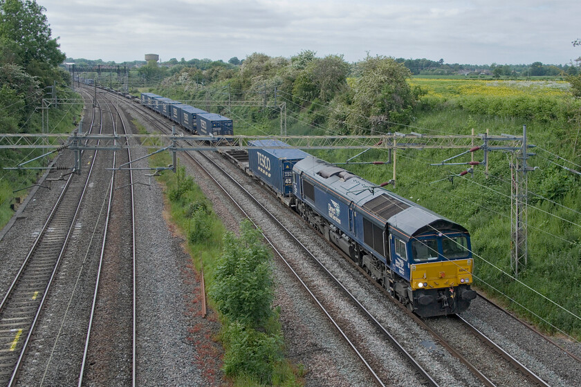 66427, 13.37 DIRFT-Tilbury (4L48, 417L), Victoria bridge 
 If it's lunchtime and a DRS train is seen heading south near Roade with Tesco wagons in tow it's the 4L48; but not today! It's teatime now and regular performer 66427 is seen leading the 13.37 DIRFT to Tilbury running over three hours late. Eventual arrival at its destination was nearly seven hours after its due time; I hope that the boxes got loaded on the appropriate ship at Tilbury! 
 Keywords: 66427 13.37 DIRFT-Tilbury 4L48 Victoria bridge DRS Tesco Express