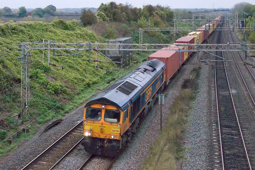 66759, 12.18 London Gateway-Hams Hall (4M47, 40L), Victoria bridge 
 66759 'Chippy' leads the 4M07 12.18 London Gateway to Hams Hall service past Victoria bridge between Roade and Ashton. Named after the late career railway man, Clive Chippington, the 66 was named in 2016. With the light fading fast there were just two more trains to wait for but will the light permit a photograph? 
 Keywords: 66759 12.18 London Gateway-Hams Hall 4M47 Victoria bridge GBRf Chippy