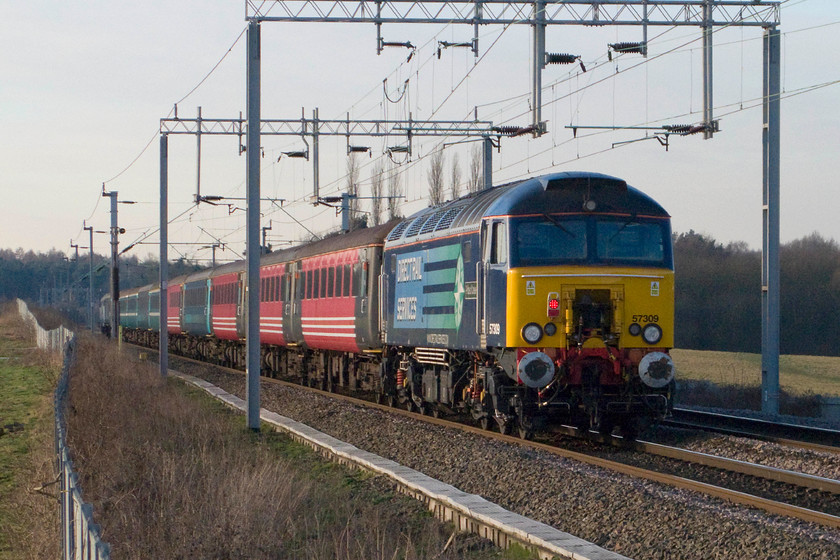 57309 13.14 London Euston-Liverpool Lime Street footex (1Z53), Wilson`s crossing 
 Since Network Rail have cleared the embankments in this area, the views have really been opened up allowing pictures to be taken in both directions. 57306 'Pride of Crewe' hangs on to the rear of the mysterious 13.14 Euston to Crewe football excursion. The train is seen passing Wilson's crossing just outside Northampton. 
 Keywords: 57309, 13.14 London Euston-Liverpool Lime Street footex (1Z53), Wilson`s crossing