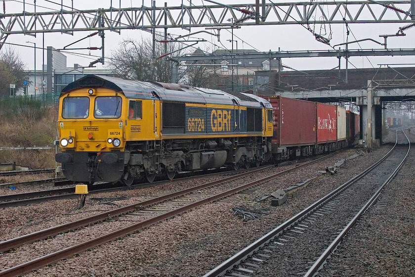 66724, 04.35 Felixstowe North-Birch Coppice (4M07, 58L), Nuneaton station 
 This was a train that was to cause us some anxious moments and some delay in the coming hour or so! 66724 'Drax Power Station' brings the 4M07 04.35 Felixstowe to Birch Coppice into Nuneaton station running at a fair speed as it did. However, within a few seconds, something was to go wrong with the train slowing and coming to a halt traversing the flyover to the north of the station. There it sat blocking the down route to Birmingham for the next couple of hours causing chaos for CrossCountry trains, other freight on this route and, ultimately, our charter. With the line blocked all Birmingham/Leicester services were forced to use platform seven utilising its bi-directional facitly to good effect! 
 Keywords: 66724 04.35 Felixstowe North-Birch Coppice 4M07 Nuneaton station GBRf Drax Power Station