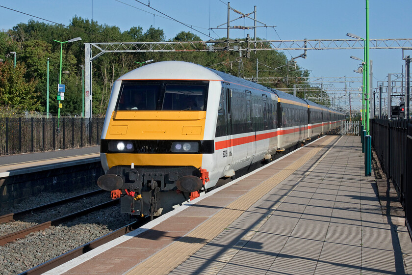 82139, 07.00 Manchester Piccadilly-London Euston (1Z93, 4L), Bletchley station 
 With a friendly toot on the peculiarly sounding horn from the driver of DVT 82139, it leads an LSL relief service train through Bletchley station. Smartly painted in its InterCity Swallow livery the DVT is leading the 07.00 Manchester Piccadilly to Euston 1Z93 powered by 90002 at the rear evoking days past on the WCML prior to the introduction of the Pendolinos twenty years ago. Having said that of course, there was a Virgin-operated peak time limited stop Euston to Birmingham service that was hauled by a Class 87 and, towards the end of its operation in 2010, a Class 90. 
 Keywords: 82139 07.00 Manchester Piccadilly-London Euston 1Z93 Bletchley station