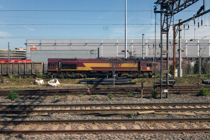 66182, up freight, Willesden yard 
 Unlike the last picture, I have used Photoshop's layers and transform functions to straighten tings up eliminating distortion that is inevitable at the lens' widest focal length of 15.1mm. Whilst this is a far more realistic image it doesn't have the same character of the last one....your choice! 66182 is seen at the head of a down freight at the southern end of Wembley yard with the Princess Royal Distribution Centre behind. 
 Keywords: 66182 up freight Willesden yard