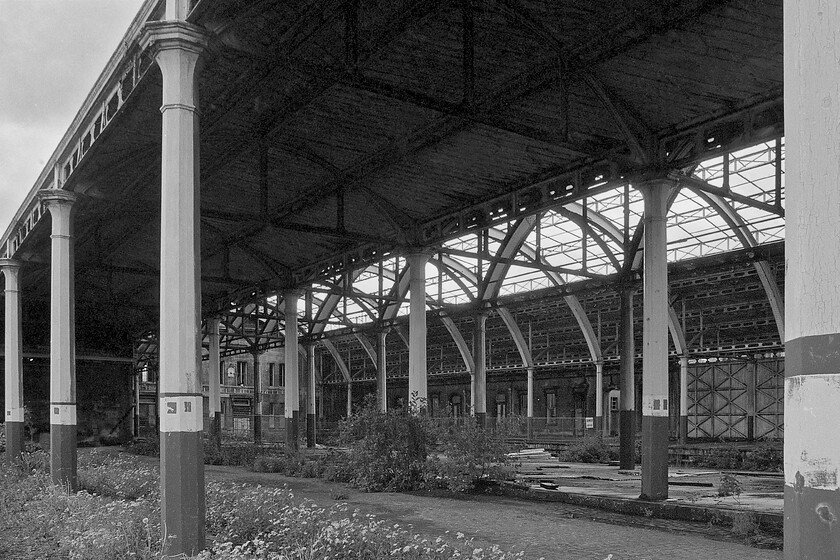 Back of platform 2, Bath Green Park station 
 A view from outside of the main station shed at Bath Green park looking towards the main building. The station was shut in 1966 (just fifteen years prior to this photograph being taken) following the closure of the Somerset and Dorset line and of the Midland route to Bristol the stub of which remains in use today as part of the Avon Valley heritage line and to the fuel oil depot at Westerleigh. 
 Keywords: Back of platform 2 Bath Green Park station