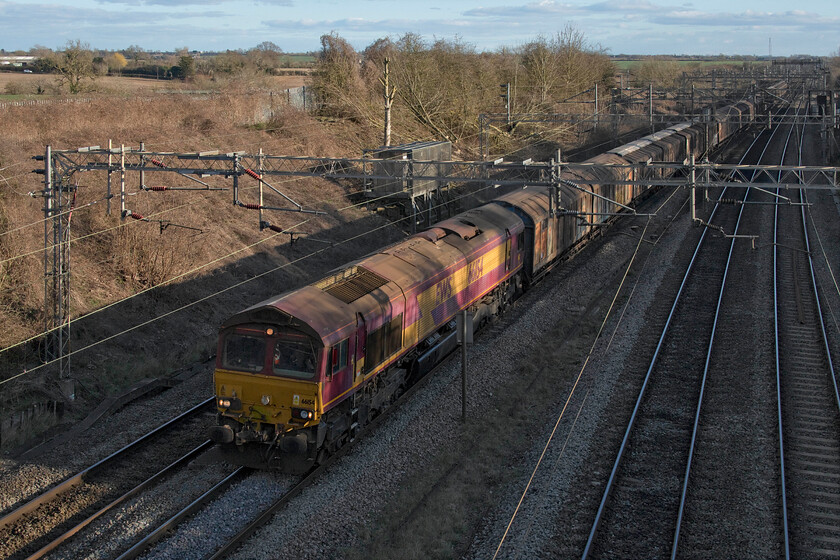 66154, 11.07 Dollands Moor-DIRFT (6M45, 32L), Victoria bridge 
 I popped my camera over my shoulder for my Sunday afternoon walk. On arrival at one of my favourite local haunts, Victoria bridge just south of Roade, the 6M45 bottled water train was due. After a short wait, it passed with an EWS liveried 66154 complete with its 'Three Beasties' branding still in place. The sun was just a little too low in the afternoon sky to fully illuminate the train but the general lighting is magnificent! 
 Keywords: 66154 11.07 Dollands Moor-DIRFT (6M45, 32L), Victoria bridge