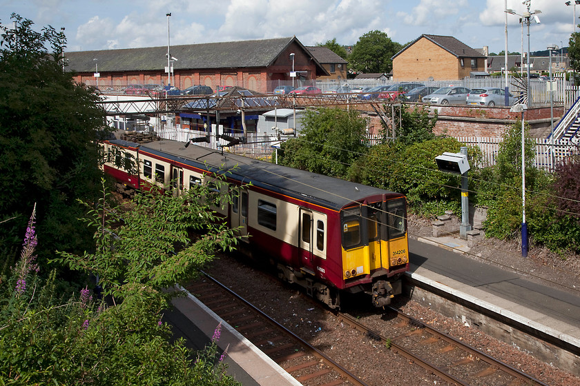 314206, SR 11.28 Neilston-Glasgow Central (2N33), Neilston station 
 Still wearing its pre-overhaul and very distinctive STP carmine and cream livery 314206 waits at Neilston station to work the 11.28 to Glasgow Central. Neilston is now a terminus station, but the line used to continue in parallel to another one below in the valley to Lugton Junction some five miles south west where they merged. 
 Keywords: 31420 2N33 Neilston station