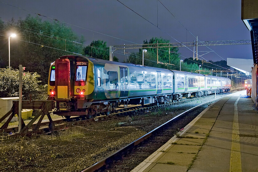 350246, stabled, Northampton Riverside Sidings 
 350246 sits stabled in Northampton's Riverside sidings. Not the finest time exposure that has needed a fair amount of work in Photoshop to 'correct' the colour cast thrown by the confusing lighting types (to the camera's sensor that is!). 
 Keywords: 350246 Northampton Riverside Sidings