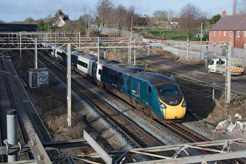 390131, VT 12.30 Birmingham New Street-London Euston (1B21, 10L), site of Roade station 
 Diverted off the fast line due to an extended closure to, amongst other things, undertake drainage improvement work 390131 'City of Liverpool' passes slowly past the site of Roade's station. The Avanti West Coast Pendolino is working the 12.30 Birmingham New Street to Euston service that had been timetabled taking an extra thirty-six minutes to make its diverted journey actually arrived just one and half minutes shy of taking two hours to complete its journey. 
 Keywords: 390131 12.30 Birmingham New Street-London Euston 1B21 site of Roade station City of Liverpool