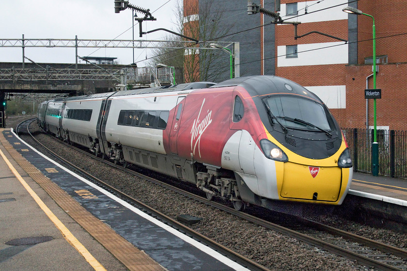 390114, VT 07.35 London Euston-Manchester Piccadilly (1H62, 1L), Wolverton station 
 390114 'City of Manchester' heads towards its namesake with the 07.35 from Euston. It is seen a full line speed racing through Wolverton station having not stopped at Milton Keynes some two miles south of this spot. 
 Keywords: 390114 07.35 London Euston-Manchester Piccadilly 1H62 Wolverton station