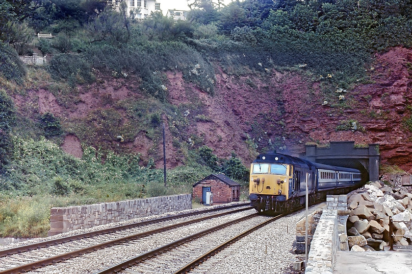 50045, 10.30 London Paddington-Plymouth (1B56), Parson`s Tunnel 
 50045 'Achilles' emerges from Parsons Tunnel with the 1B56 10.30 London Paddington to Plymouth. With no view up the 'line, being ready for a picture was tricky. The only warning of a trains arrival was when the welded track began to 'sing', giving just enough time to get the camera to the eye and to fire, hoping the shutter speed and aperture settings were correctly set up! 
 Keywords: 50045 10.30 London Paddington-Penzance 1B56 Parson`s Tunnel