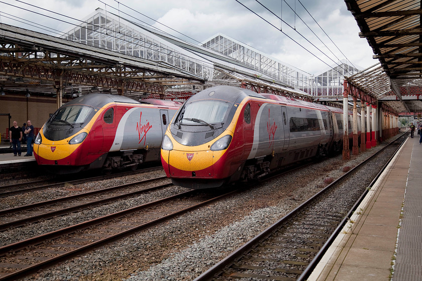 390011, VT 13.07 London Euston-Liverpool Lime Street (1F17) & 390016, VT 11.40 Glasgow Central-London Euston (1M12), Crewe station 
 A passing of Pendolinos at Crewe station. Whilst 390011 'City of Lichfield' pauses working the 13.07 Euston to Liverpool Lime Street, 390016 passes through the centre road with the 1M12 11.40 Glasgow Central to Euston. 
 Keywords: 390011 13.07 London Euston-Liverpool Lime Street 1F17 390016 11.40 Glasgow Central-London Euston 1M12 Crewe station