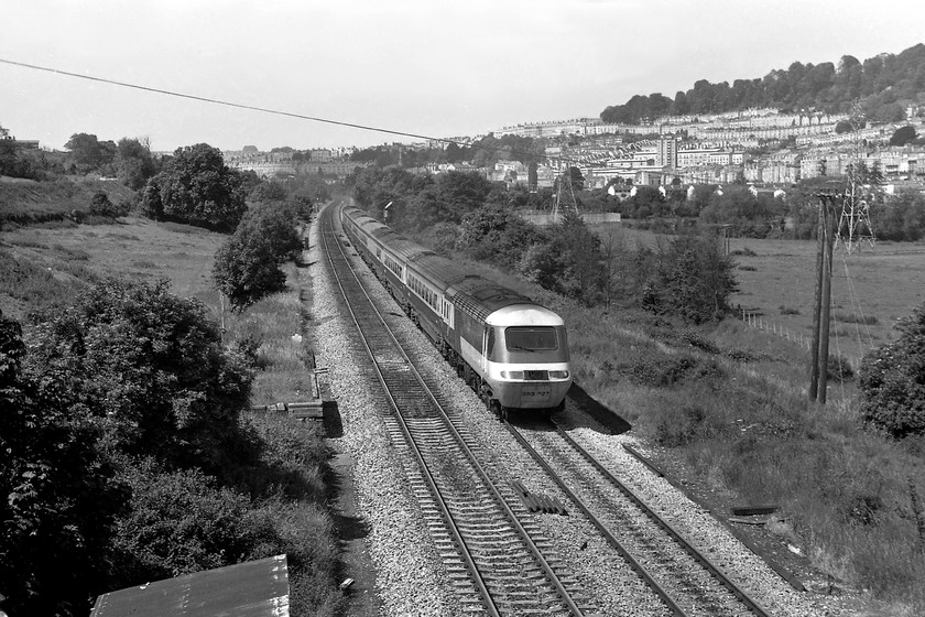 253027, unidentified up working, Bathampton ST769662 
 With the beautiful city of Bath in the background, 253027 accelerates away from it with an unidentified up working for London Paddington. The picture is taken from an occupation bridge a short distance west of Bathampton. This power car is going to be one of 43054 or 43055, both of which are still in operation in 2019 on the MML. 2024 Update.....43055 is still in mainline operation now as part of the charter market operated by LSL as one of their Blue Pullman power cars. 
 Keywords: 253027 up working Bathampton ST769662 HST