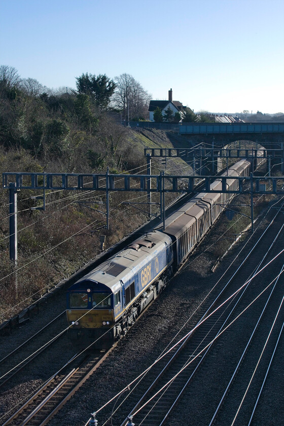 66797, 06.53 Dollands Moor-DIRFT (6M41, RT), Hyde Road bridge 
 With much freight cancelled during the Christmas and New Year period one flow that continued to run was the 'water train'. The 6M41 06.53 Dollands Moor to DIRFT (Daventry) passes through Roade led by 66797 catching some welcome (but troublesome for photography) winter sunshine in the cutting. 
 Keywords: 66797 06.53 Dollands Moor-DIRFT 6M41 Hyde Road bridge