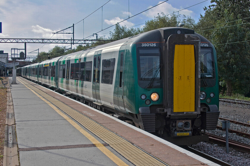 350126, LN 09.56 London Euston-Birmingham New Street (1Y25, 4L), Northampton station 
 Our train from Northampton to Birmingham New Street waits to leave our 'home' station as the 09.56 from Euston. We travelled on the leading unit of this train which was one of the first batches of Desiros delivered back in the late 'noughties' designated as 350/1s and have a superior 2 + 2 seating arrangement compared to the later 350/2 subset with. more cramped 2 + 2 set up. 
 Keywords: 350126 09.56 London Euston-Birmingham New Street 1Y25 Northampton station London Northwestern Desiro