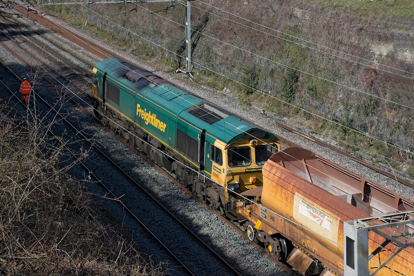 5. 66565, ballast train, Hyde Road bridge 
 Under power and at less than walking pace 66565 eases a partially loaded ballast train composed of a short rake of HQA(E) autoballasters back towards a work site at the site of Roades former station. With the driver of the 66 sitting in his seat facing the wrong way and running blind, communications would have been via mobile phones no doubt 
 Keywords: 66565 ballast train Hyde Road bridge HQA(E) autoballasters