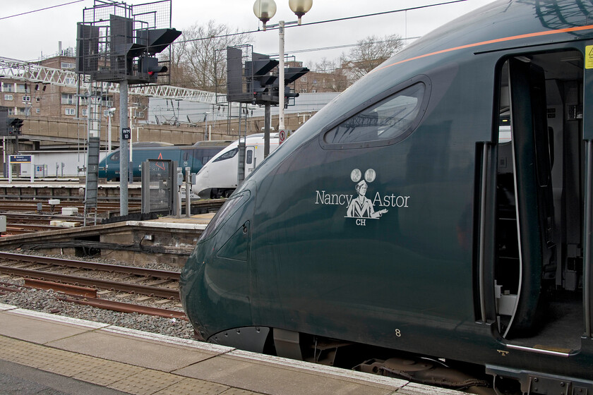 390126, VT 06.52 Edinburgh Waverley-London Euston (9M50, 1L), 805006, 14.03 London Euston Edge Hill Depot (5Q92, RT) & 802101 , 14.06 London Euston-North Pole Depot (5Q85, 4E), London Euston station 
 An unusual lineup at Euston station sees the more usual Pendolino at the far end. 390126 has just arrived having worked the 06.52 from Edinburgh Waverley. The second closest to the camera is one of the new and unbranded bi-mode Class 805s undergoing yet another mileage accumulation and driver training run. 805006 will work the 5Q52 14.03 train to Edge Hill depot in Liverpool. Lastly, in the foreground is an interloper from western lines. 802101 'Nancy Astor' will leave at 14.06 as the 5Q85 to North Pole Depot. As the crow flies it is not very far and easily done in half an hour or so by public transport or bike but by rail considerably longer via two reversals, one at Willesden Yard and another at Kensington Olympia. This rather convoluted route could see these trains taking next Christmas offering a partial service to stations west during the lengthy closure of the GWML out of Paddington. 
 Keywords: 390126 06.52 Edinburgh Waverley-London Euston 9M50 805006 14.03 London Euston Edge Hill Depot 5Q92 802101 14.06 London Euston-North Pole Depot 5Q85 London Euston station AWC Avanti West Coast Pendolino Nancy Astor GWR IET