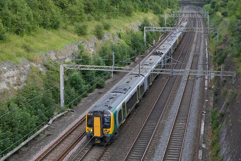 350123 & 350106, LM 17.49 London Euston-Birmingham New Street (1W23), Roade cutting 
 Two of the initial batch of Class 350s from the 350/1 sub set pass through Roade cutting working the 17.49 Euston to Birmingham New Street. 350123 and 350106 are ten years old now and have performed well being amongst the most reliable units on the national network. 
 Keywords: 350123 350106 17.49 London Euston-Birmingham New Street 1W23 Roade cutting London Midland Desiro