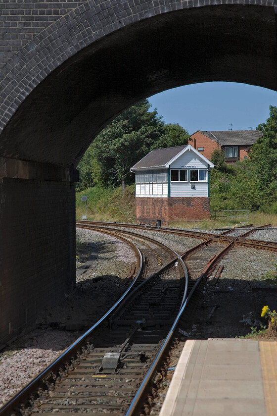 Poulton No.3 signal box (L&Y, 1896) 
 Framed by the bridge that carries Breck Road over the railway in front of the station Poulton No. 3 signal box is seen. The line to its left heads onwards to Blackpool North whilst the line to the right, even though it looks to be in use, is in fact the closed branch to Fleetwood. There are frequent plans put forward to re-open this line possibly as some sort of light transit system. The box is a superb Lancashire and Yorkshire standard design that was opened in 1896. It has a substantial seventy-four lever frame installed but I believe that just nine remain in use today. When the plans to electrfy the line to Blackpool from Preston the route will also be re-signalled bringing an end to the mechanical signalling; get your pictures while you can.

NB The box was to close on 11.11.17 and was demolished on 20/21.02.18 
 Keywords: Poulton No.3 signal box L&Y Lancashire and Yorkshire