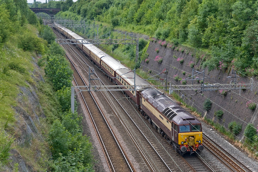 57305, outward leg of DBS excursion, Liverpool Lime Street-Bletchley (& on to London Euston) (1Z58), Roade cutting 
 With 47813 'Solent' doing all the work at the front, 57305 'Northern Princess' swings about on the rear of the DBS staff excursion from Liverpool Lime Street to Bletchley and thence on to Euston. The train is seen passing through Roade Cutting approaching the end of its journey from the north-west. 
 Keywords: 57305 DBS excursion Liverpool Lime Street-Bletchley London Euston 1Z58 Roade cutting Belmond Northern Belle Northern Princess