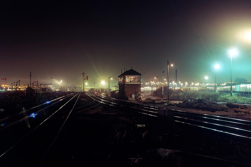 Cricklewood Junction signal box (LMS, c1929) & signalling 
 I love this photograph! Taken at night from the northern platform end of Cricklewood station it shows the running lines and signal box. To the right is Cricklewood depot with a class 47 on view along with a lot of stock. The lamps shining through the glasses of the semaphores stand out against the dark winter sky. 
 Keywords: Cricklewood Junction signal box signalling