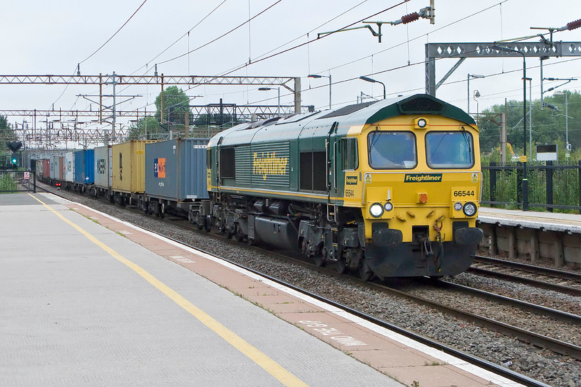 66544, 06.04 Crewe Basford Hall-Felixstowe (4L41), Northampton station 
 On a grey June morning, 66544 takes the centre road through Northampton station leading the 4L41 06.04 Crewe Basford Hall to Felixstowe Freightliner. At busy times, the passage of freight through Northampton can be problematic to the south of the station as it is a bit of a bottleneck with service trains often holding things up waiting for platforms to become available. 
 Keywords: 66544 06.04 Crewe Basford Hall-Felixstowe 4L41 Northampton station Freightliner