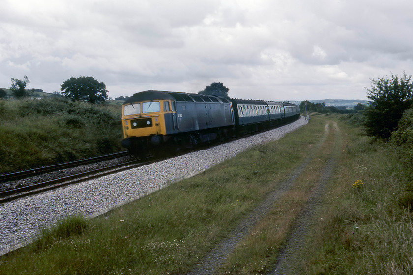 47152, 08.15 Plymouth-Leeds (1E30), Burlescombe ST071168 
 47152 heads the 08.15 Plymouth to Leeds service on the climb to Whiteball tunnel at Burlescombe. It has just passed the Whiteball distant signal, a colour light, controlled by Whiteball signal box some mile and a half away. At this time 47152 was a Bristol Bath Road locomotive spending a lot of its life on the Western Region. It had spells in Scotland and the Midlands before becoming a Railfreight Distribution (and lately Freightliner) locomotive in 1990 with withdrawal and scrapping coming in May 2001. 
 Keywords: 47152 08.15 Plymouth-Leeds 1E30 Burlescombe ST071168