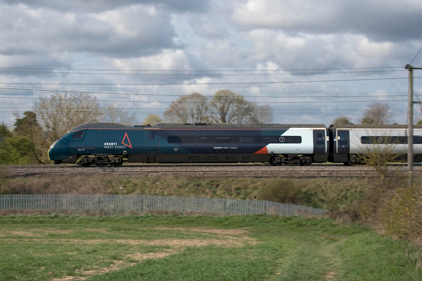 390118, VT 08.05 Manchester Piccadilly-London Euston (1A02, 9E), between Roade & Ashton 
 Following on from the previous photograph, see.... https://www.ontheupfast.com/p/21936chg/30013731724/x390117-08-05-wolverhampton-london this very similar image utilises the panning technique to capture the subject relatively sharp with the background deliberately blurred. It is a little hit and miss not always working and in this case, the subject is not quite pin sharp. 390118 heads south between Roade and Ashton working the 1A02 08.05 Manchester to Euston Avanti West Coast train. 
 Keywords: 390118 08.05 Manchester Piccadilly-London Euston 1A02 between Roade & Ashton Avanti West Coast Pendolino