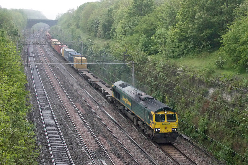 66568, 03.25 Garston-London Gateway (4L52), Hyde Road bridge 
 In truly awful lighting, 66568 makes its way slowly through Roade cutting with the 03.25 Garston to London Gateway Freightliner. To give one the idea of how bad the lighting was, I needed 6400 ISO on the camera to manage 1/1250 of a second! This did create some issues with digital noise that needed taking care of. 
 Keywords: 66568 03.25 Garston-London Gateway 4L52 Hyde Road bridge