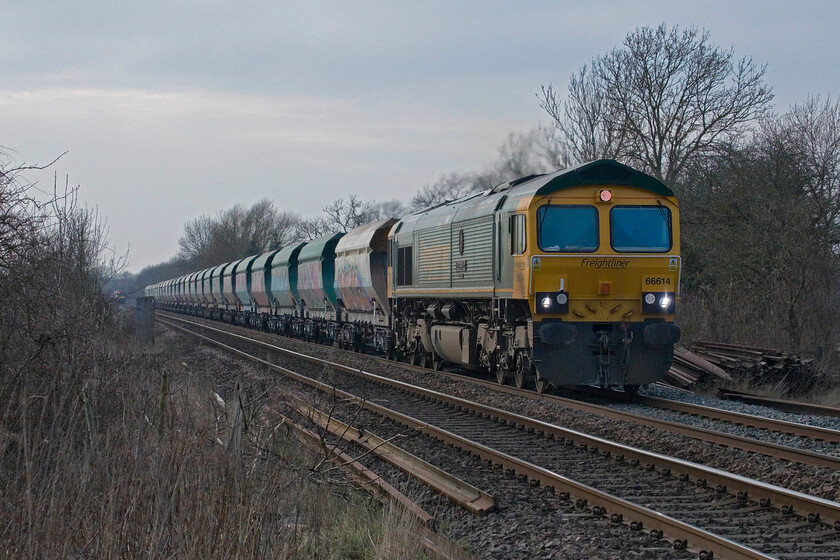 66614, 11.52 Tunstead Sidings-Elstow Redland Sidings (6D17, 1L), Frisby level crossing 
 66614 '1916 Poppy 2016' approaches Frisby level crossing leading the 6D17 11.52 Tunstead Sidings to Elstow aggregates train. It is towing a rake of heavily graffitied former HIA coal hoppers now repurposed for stone use. 
 Keywords: 66614 11.52 Tunstead Sidings-Elstow Redland Sidings 6D17 Frisby level crossing 1916 Poppy 2016