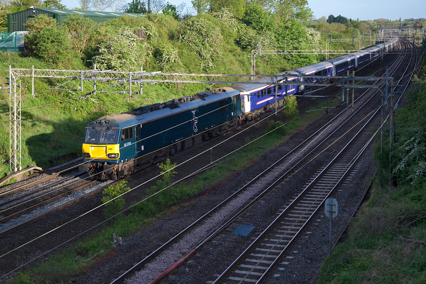 92018, CS 20.45 Inverness 21.43 Aberdeen 19.50 Fort William-London Euston sleeper (1M16, RT), Victoria Bridge 
 With just a bit of sun on the nose of 92018 as it passes Victoria Bridge on the southern WCML near to Roade in Northamptonshire with the 1M16 Caledonian Sleeper with portions from Inverness, Aberdeen and Fort William. The Mk. III sleepers were on borrowed time when this picture was taken as the new stock was just beginning testing. 
 Keywords: 90018 sleeper 1M16 Victoria Bridge