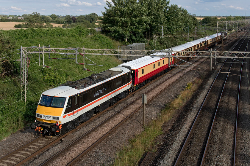 90002 & 87002, 15.35 Crewe HS-Euston (5Z90, RT), Victoria bridge 
 90002, renamed from 'Eastern Daily Press 1870-2010 Serving Norfolk for 140 Years' to 'Wolf of Badenoch', the name previously carried by the now-scrapped 87027, is seen at the rear of the 5Z90 15.35 Crewe to Euston and return. This unusual train, being led by 90002 'Royal Sovereign', was operated by Saphos Trains that is the charter arm of Jeremy Hosking's Locomotive Services Limited group that owns and operates the stock seen here made up of Mk.2fs 9479, 3312, 6708, Mk.1 buffet 80043 and former Caledonian Sleeper Mk.3 10520. It was acting as a test run prior to the first railtour to operate since 21st March that would run from Crewe to Carlisle via the Settle and Carlisle the following day hauled by 70000 'Britannia'. The train is seen passing Victoria bridge between Northampton and Milton Keynes in a rare burst of afternoon sunshine! 
 Keywords: 90002 87002 15.35 Crewe HS-Euston 5Z90 Victoria bridge InterCity Swallow livery Royal Sovereign Wolf of Badenoch