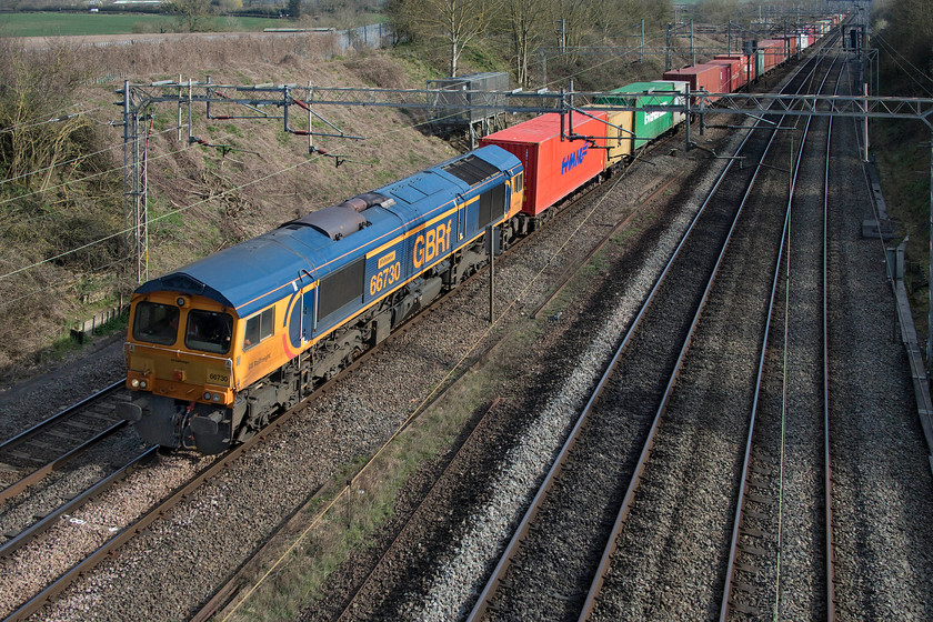 66730, 10.36 Felixstowe North-Hams Hall (4M23, 14L), Victoria bridge 
 GBRf's 66730 'Whitemoor' passes Victoria bridge just south of Roade with the 10.36 Felixstowe North to Hams Hall Freightliner. This northbound 4M23 working was more heavily loaded than others observed during the day even though the rear third of the train was just flats with no boxes. 
 Keywords: 66730 10.36 Felixstowe North-Hams Hall 4M23 Victoria bridge Whitemoor